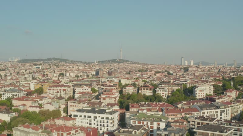 Endless Rows of Houses on Hillside in Istanbul with New TV Tower in background, Aerial forward tilt down