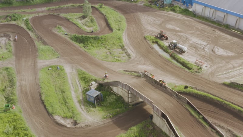 Tracking Shot of a Motorcross Driver Driving Across a Track in the Netherlands.