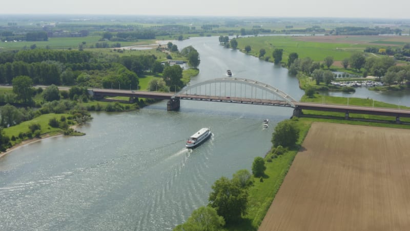 River transport vessels passing under highway bridge