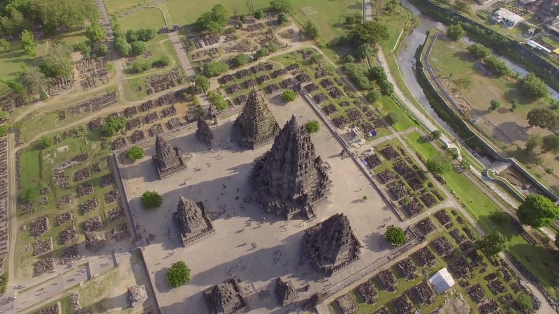 Aerial view of people visiting a preserved archaeological ruin.