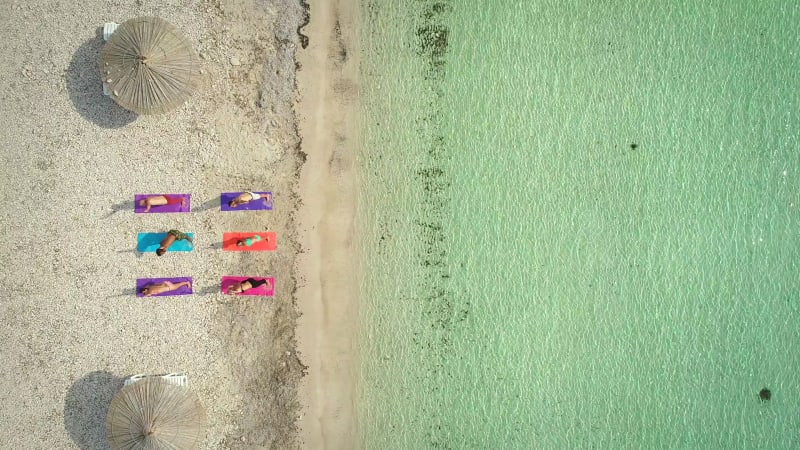 Aerial view of group of people in yoga pose.