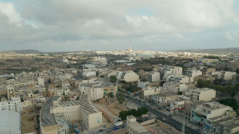 Fast moving Hyperlapse over Gozo Island, Malta with Church in distance and Overcast Sky, Aerial forward dolly