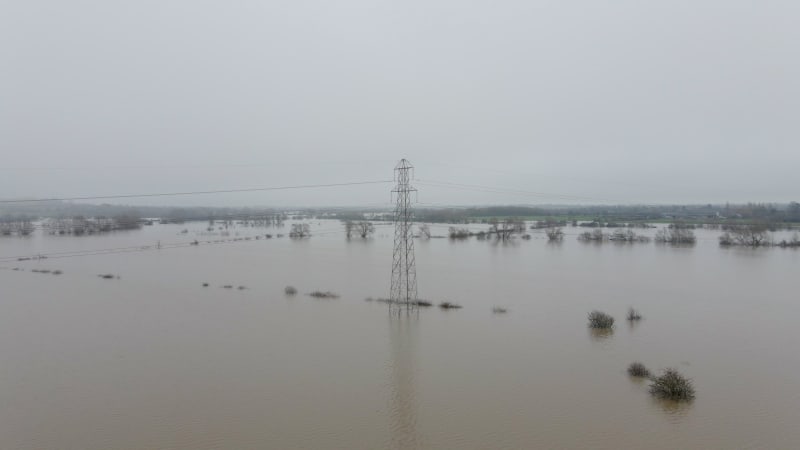 An Electricity Pylon in Deep Water in a Floodwaters Causing Power Outages