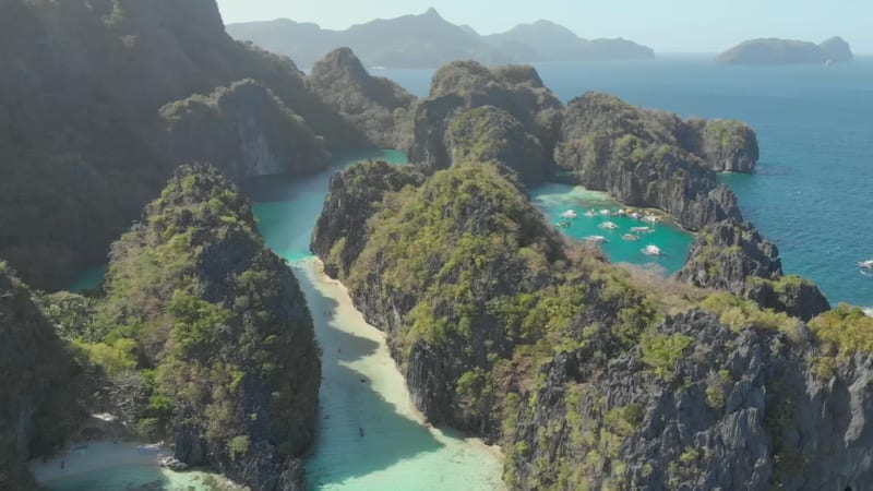 Aerial view of Big Lagoon with outrigger boats, El Nido