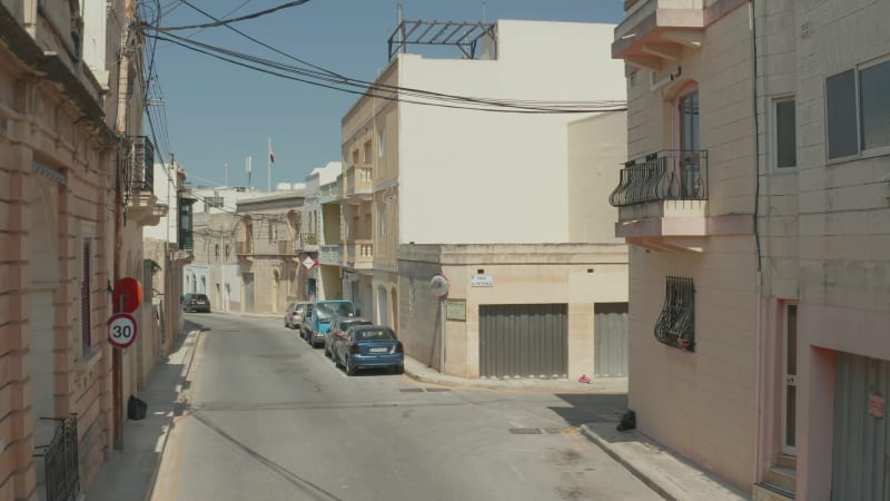 Small mediterranean Town Empty Street because of Coronavirus Covid 19 Pandemic and Lockdown, Aerial dolly forward between Beige and Sand Colored Houses