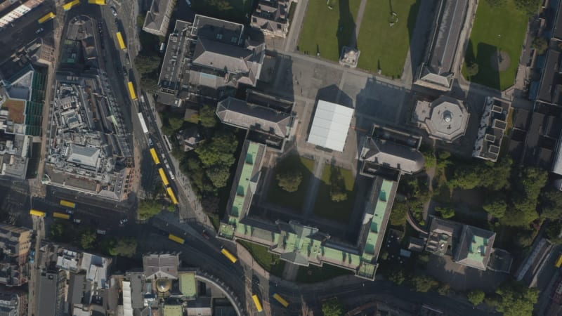 Aerial birds eye overhead top down panning view of streets blocked by yellow town buses. Bus drivers block strike. Dublin, Ireland