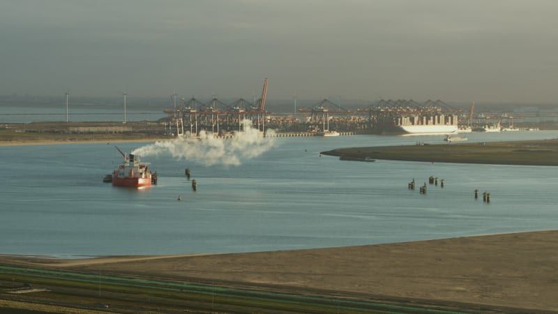 Running Cargo Ship In Front Of A Harbor