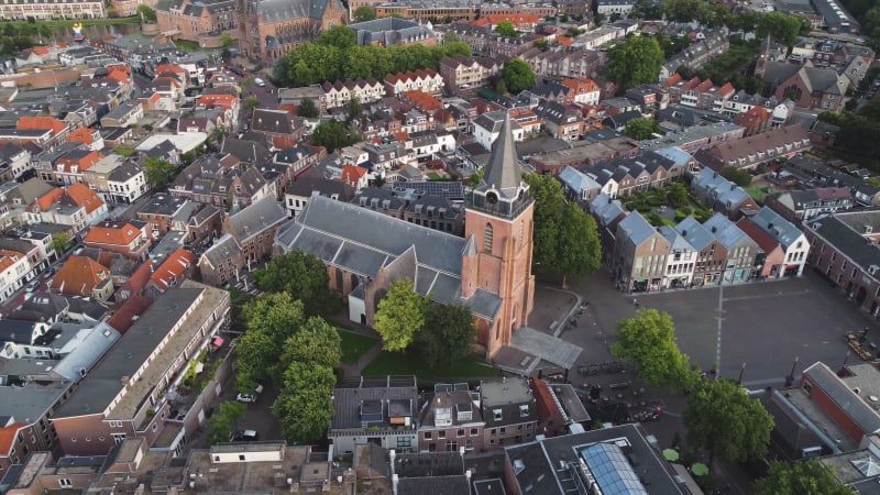 Rotating distant view of chapel, residential houses and streets in Woerden, Netherlands.