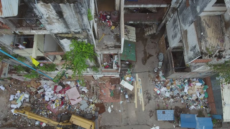 Aerial view of workers dismantling a abandoned building.