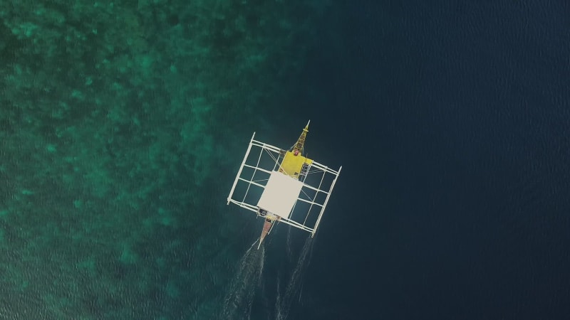 Aerial view of single filipino fishing boat near Lapu-Lapu city.