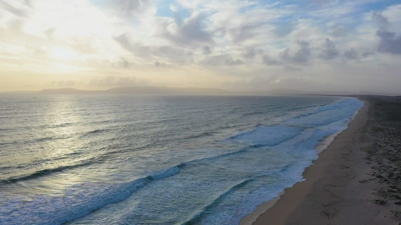 Aerial view of sandy beaches and waves.