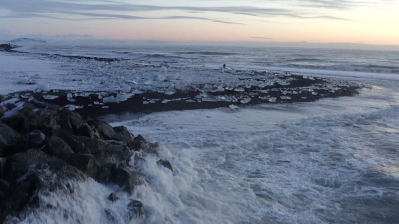 Waves crashing onto Rocks on Black,  Diamond Beach in Iceland in Winter Snow, Ice, Waves, Water