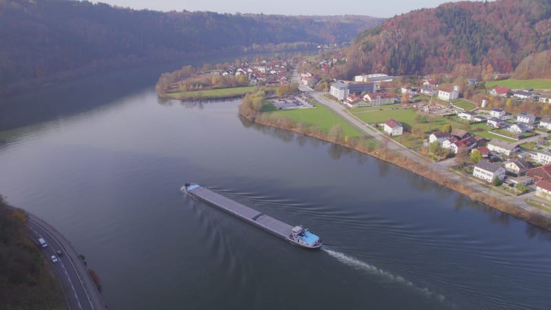 Cargo Pusher Boat on a River Transporting Cargo and Goods Along a River Bend