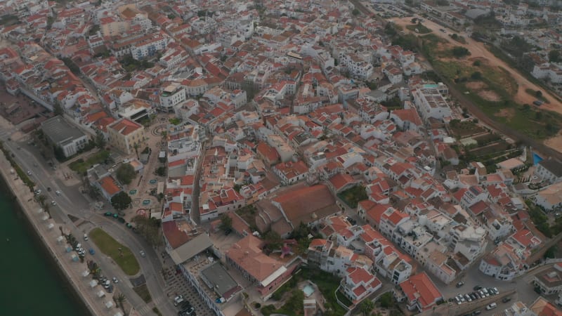 Amazing aerial drone view flying above Lagos city in Algarve, Portugal, circle pan, day