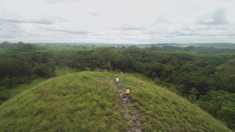 Aerial view group people hiking Chocolate Hills Complex.