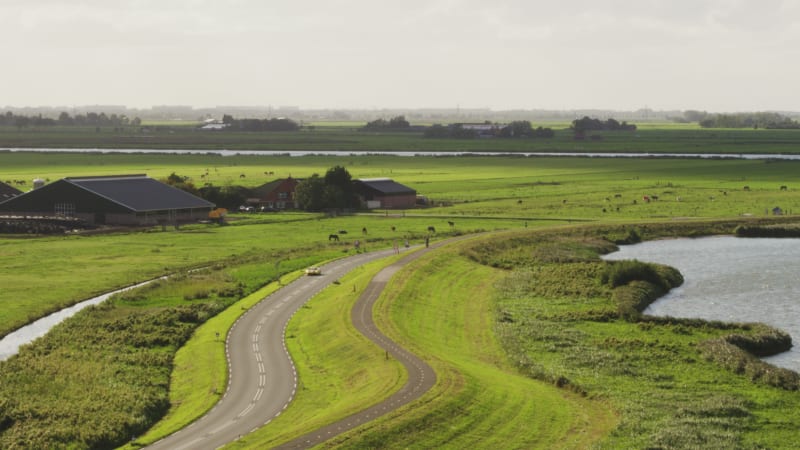 Speeding Car Across a Dutch Field and Homes