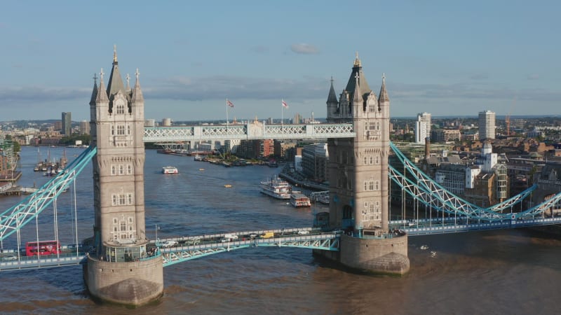 Forwards fly above Tower Bridge. Heavy traffic on road through historic landmark spanning River Thames. London, UK