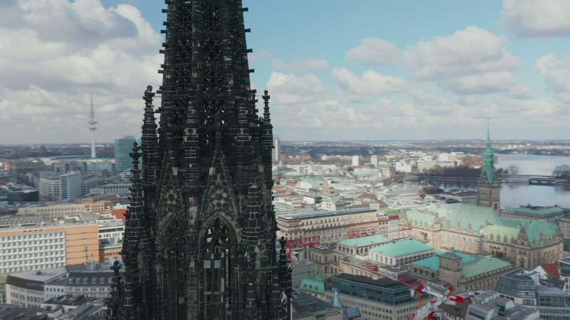 Close up aerial orbit of dark church spire of St. Nikolai world war Memorial and Museum in Hamburg, Germany