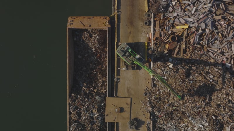 Aerial birds eye overhead top down footage of transporting separated material for recycling. New York City, USA