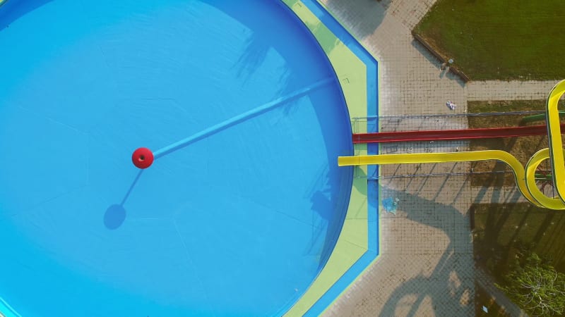 Aerial view of empty pool with slides in abandoned aqua park.