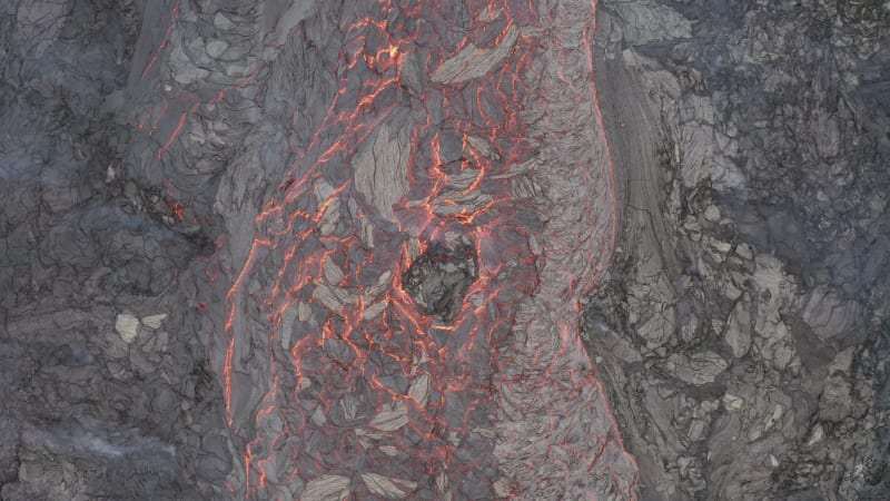 Steaming lava flows slowly at Fagradalsfjall volcano eruption site in Iceland.