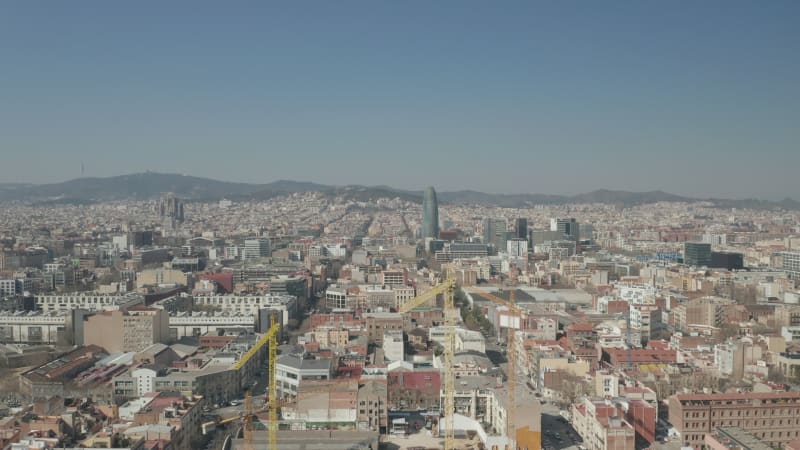 Barcelona Wide Drone Shot of City Towards Center with La Sagrada Familia and Torre Glories, Torre Agbar