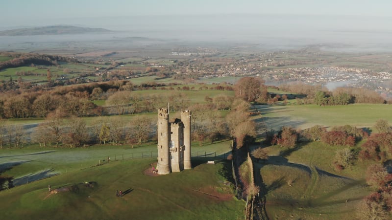 Broadway Tower, a famous iconic tourist attraction in The Cotswolds Hills, iconic English landmark with beautiful misty British countryside scenery, Gloucestershire, England, UK