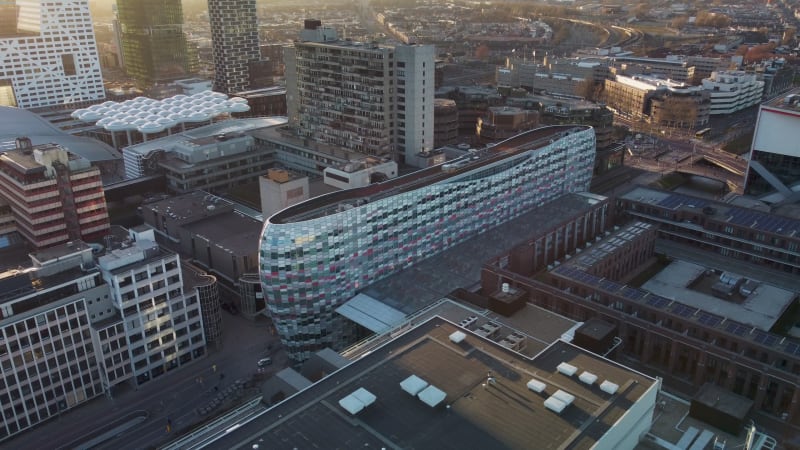 Contemporary building with mirror windows between office buildings in Utrecht city center, Netherlands.