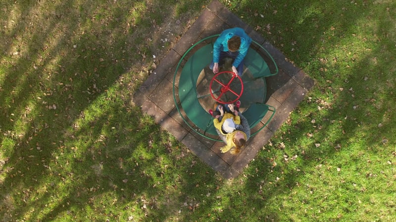 Aerial view of family enjoying day at merry-go-round.