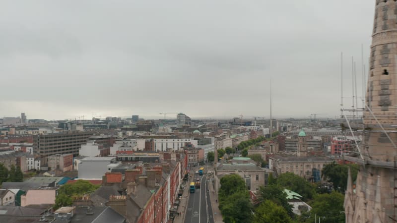 Forwards fly above town, around tower of Abbey Presbyterian Church to Ambassador Theatre with view of Monument of Light. Dublin, Ireland