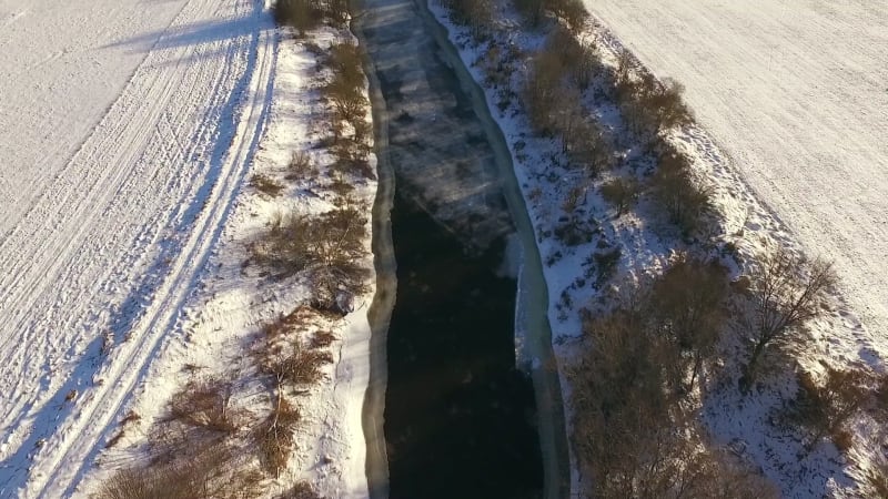 Aerial view of Vaana Jogi river surrounded by snow in winter.