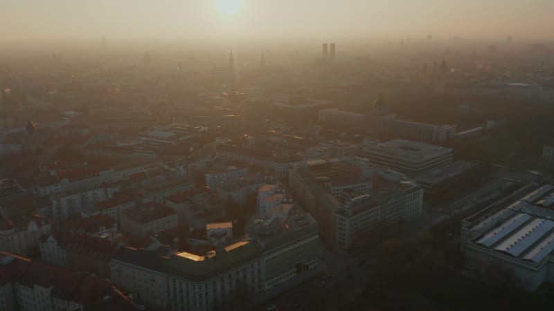 Beautiful Winter Haze Fog in the air above Cityscape of Munich, Germany, Scenic Aerial View with Cathedrals and Frauenkirche