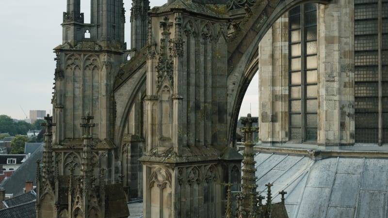 An aerial perspective captures the maintenance and restoration scaffolding the majestic Dom tower in the historic city of Utrecht.