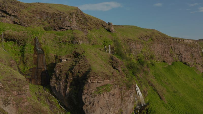 Aerial view of amazing mossy highlands in southern Iceland. Drone view of stunning rocky formations of Seljalandsfoss waterfall, one of most important touristic destination