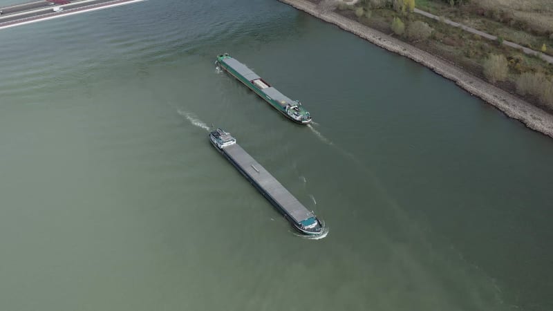 Barges Passing Under a Cable Stayed Suspension Bridge With Vehicles Crossing