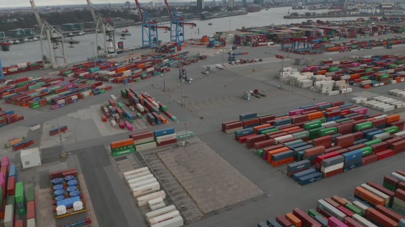 Forklifts driving around cargo container terminal in Hamburg port