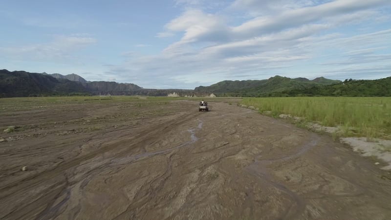 Aerial view following off road jeep in the valley on Tarlac.