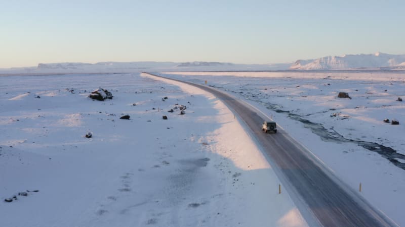 Snow White Landscape with Road following Jeep in Iceland at Sunset Winter, Sun, Arctic