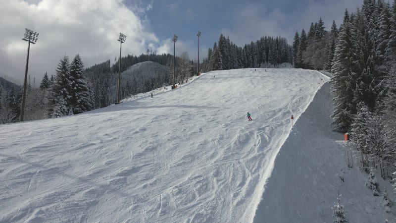 Low Flying Aerial View of a Ski Slope for Night Skiing in Flachau, Austria by daytime.