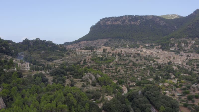 Valldemossa in Mountains with View on Castle in the Distance and Street with Cars on Tropical Island Mallorca, Spain on Sunny Day Vacation, Travel, Sunny