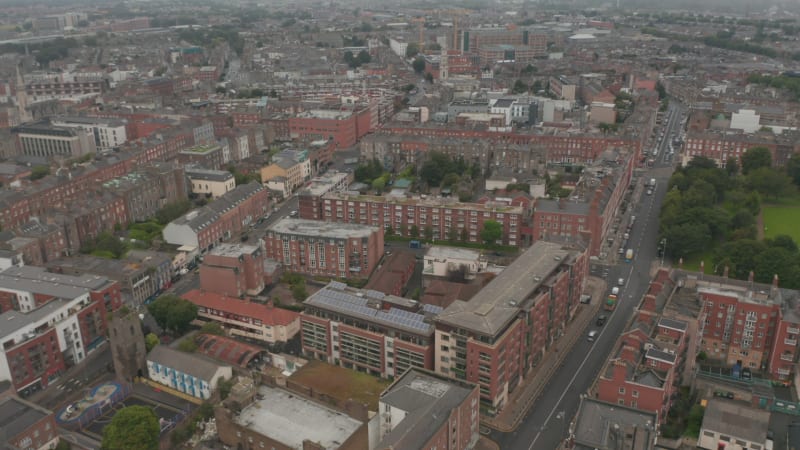 Aerial panoramic view of urban neighbourhood. Vehicles driving in street. Red brick houses. Dublin, Ireland