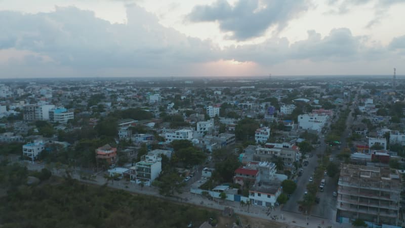 Aerial cityscape of Playa del Carmen, Mexico. Flying above multistorey buildings, hotels and residential area