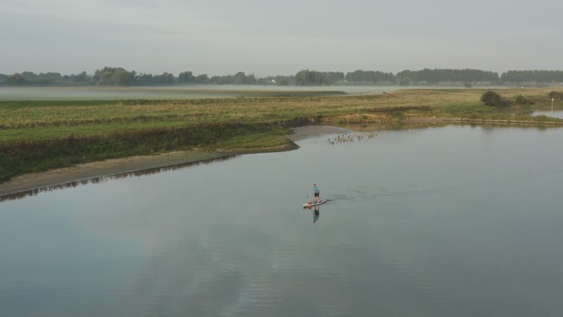 Pull Away Shot of a Stand Up Paddle Board in the Lek River, the Netherlands