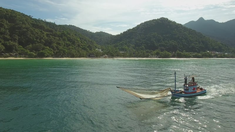 Aerial view of a motorboat navigating on calm water, Ko Chang.