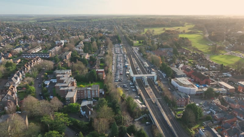 Commuter Train Arriving at a Railway Station in the UK at Sunset