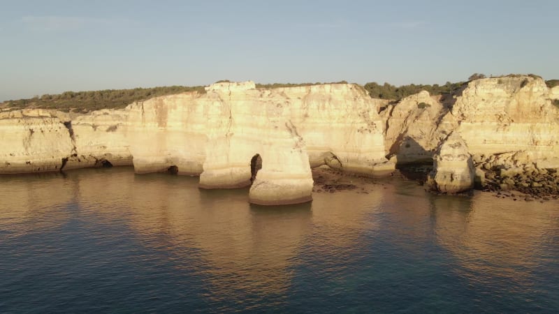 Aerial view of cliff arch during sunrise at Marinha Bay