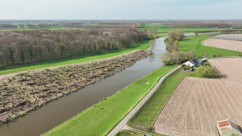 Aerial view of river Linge with road, mill and orchards, Betuwe, Netherlands