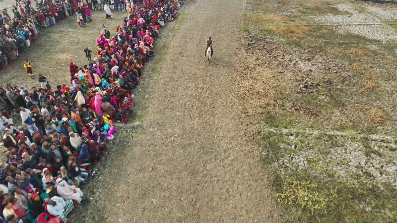 Aerial view of people watching horse race in Mohanpur, Bangladesh.