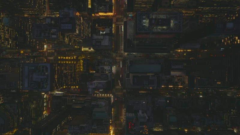 Aerial birds eye overhead top down view of streets in city centre. Downtown at night from height. Manhattan, New York City, USA