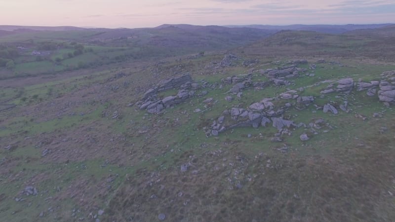 Granite rock landscape in Dartmoor National Park at sunset, Devon, England, UK. Aerial drone view